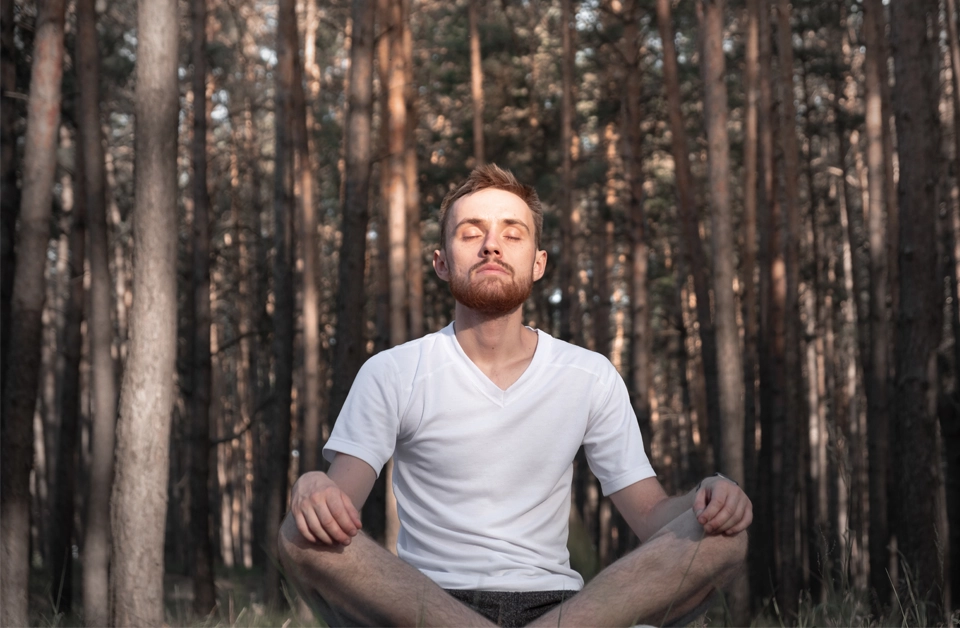 Someone taking in a large breath outdoors.